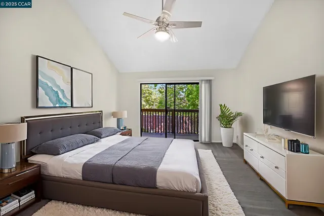 a bedroom with a large bed and a flat screen tv
