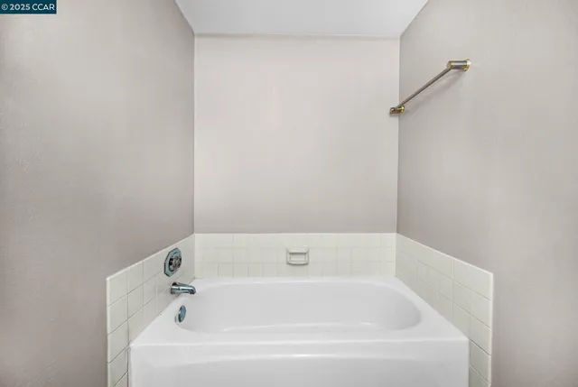a white bath tub and shower in it