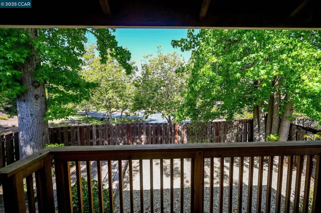 a view of wooden fence with trees in the background