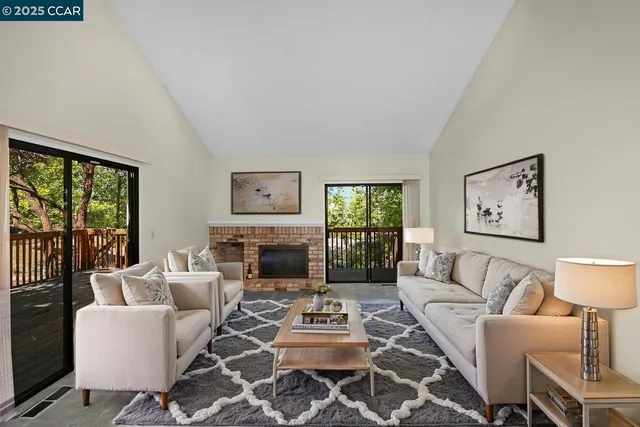 a living room with furniture a table and a large window