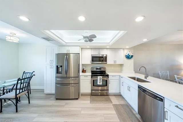 a kitchen with stainless steel appliances granite countertop a refrigerator and a stove top oven