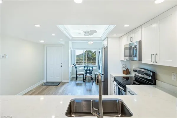 a view of kitchen with sink and window