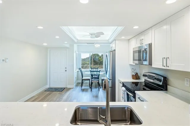 a view of kitchen with sink and window