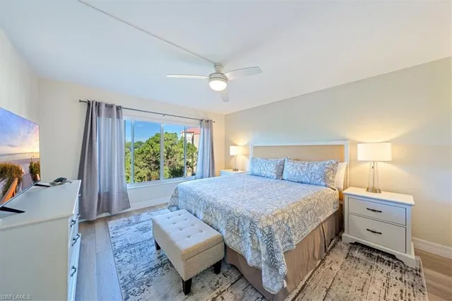 a bedroom with a bed mirror and window