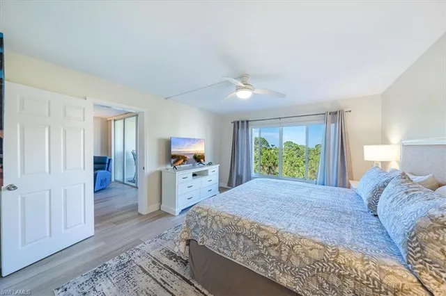 a large bedroom with a bed and a flat screen tv