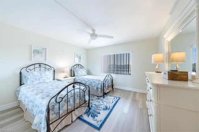 a bedroom with two beds and a table