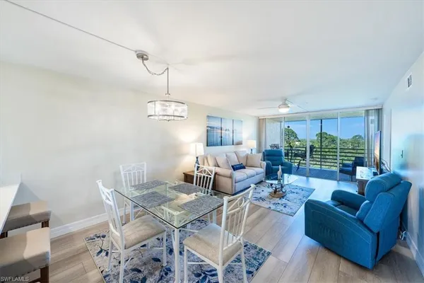a living room with furniture a window and a table
