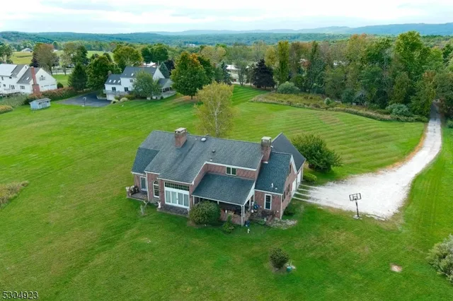 an aerial view of a house with big yard