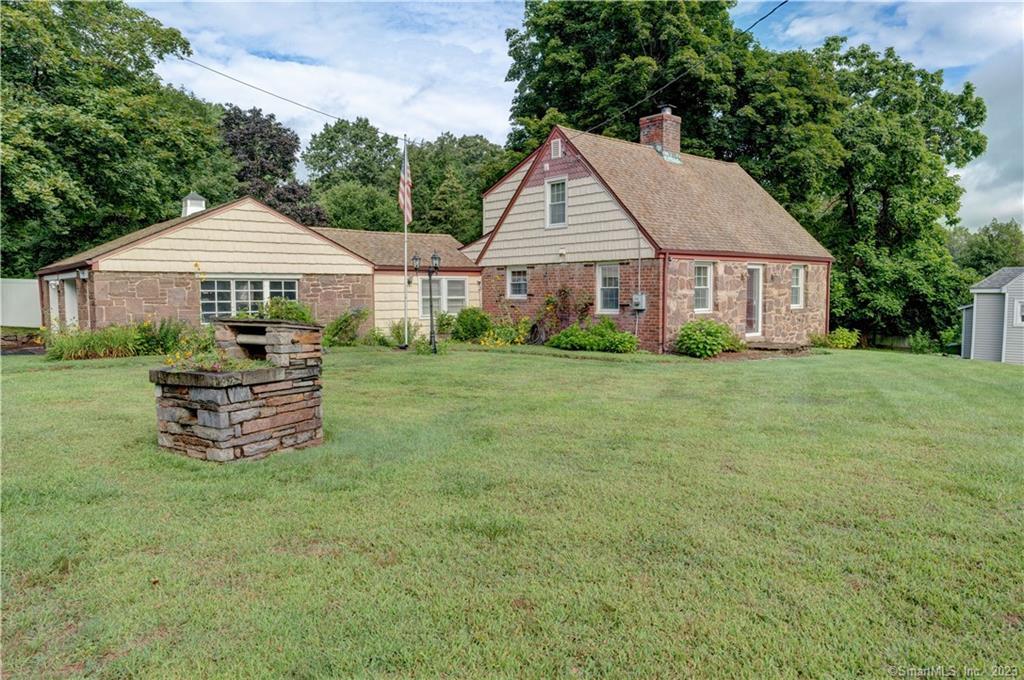 679 Main Street Cromwell, CT 06416 - Photo 1 of 1 a view of a house with a yard and sitting area