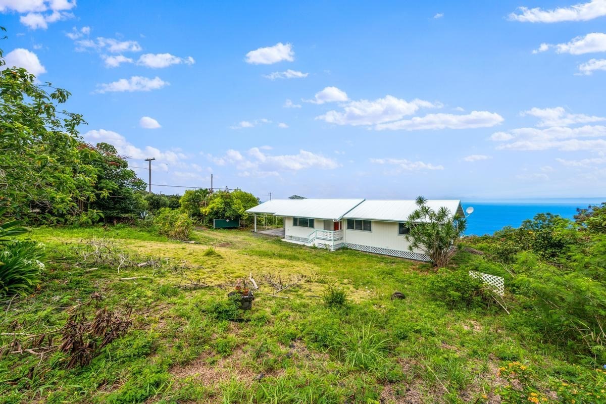 88-2259 Milolii Road Captain Cook, HI 96704 - Photo 1 of 30 a big yard with lots of green space and plants
