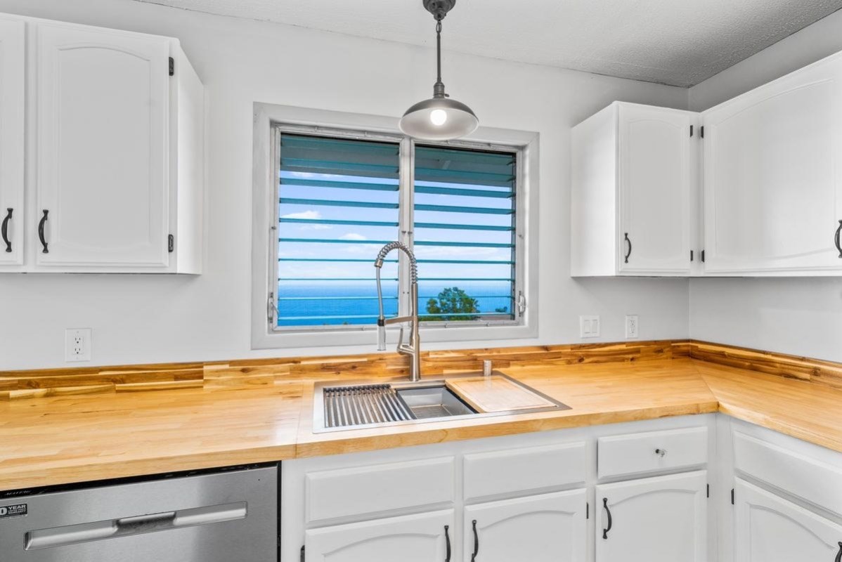 88-2259 Milolii Road Captain Cook, HI 96704 - Photo 7 of 30 a kitchen with a sink and cabinets