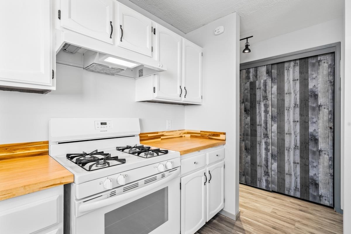 88-2259 Milolii Road Captain Cook, HI 96704 - Photo 10 of 30 a kitchen with cabinets and appliances