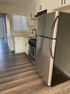 a kitchen with granite countertop a refrigerator and a stove