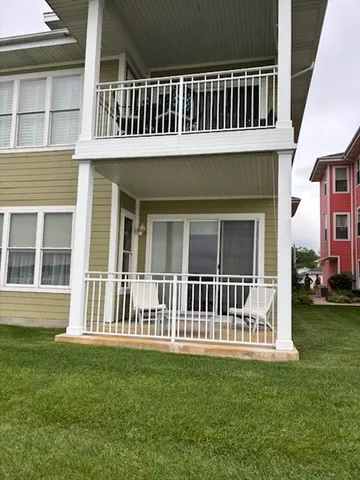 a view of a house with a backyard and porch
