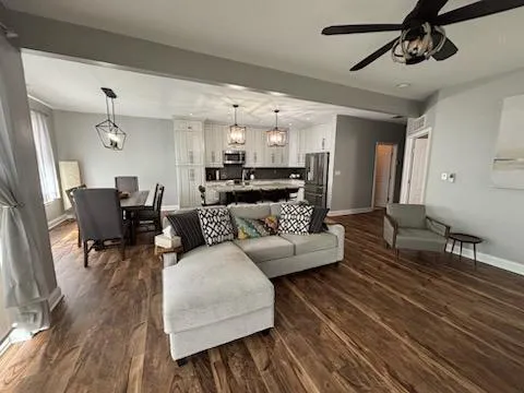 a living room with furniture and wooden floor