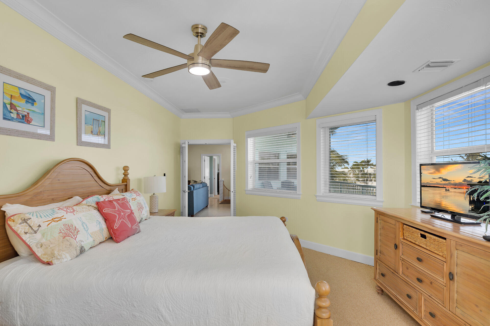 580-590 10th Street Key Colony Beach, FL 33051 - Photo 28 of 75 a bedroom with a large bed and a flat tv screen on dresser