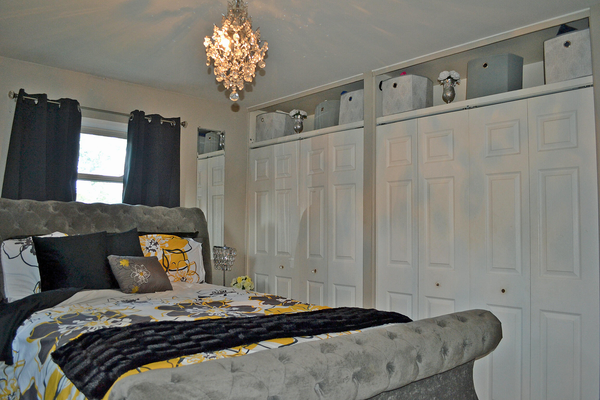 3718 173rd Court Hammond, IN 46323 - Photo 13 of 30 a bedroom with a bed and a chandelier