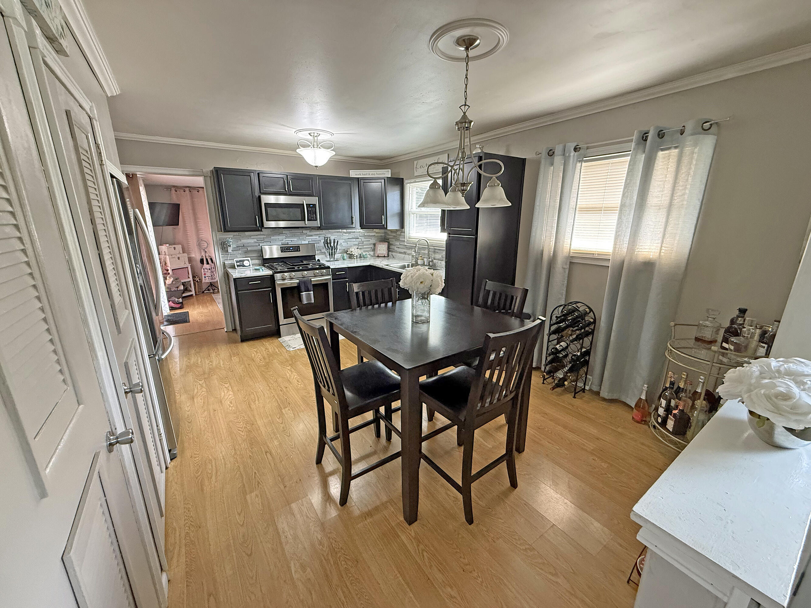3718 173rd Court Hammond, IN 46323 - Photo 6 of 30 a view of a dining room with furniture and wooden floor