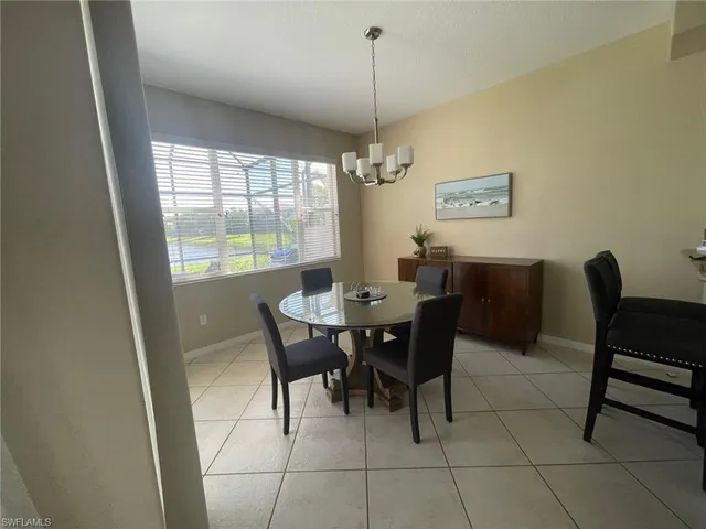 a view of a dining room with furniture and window