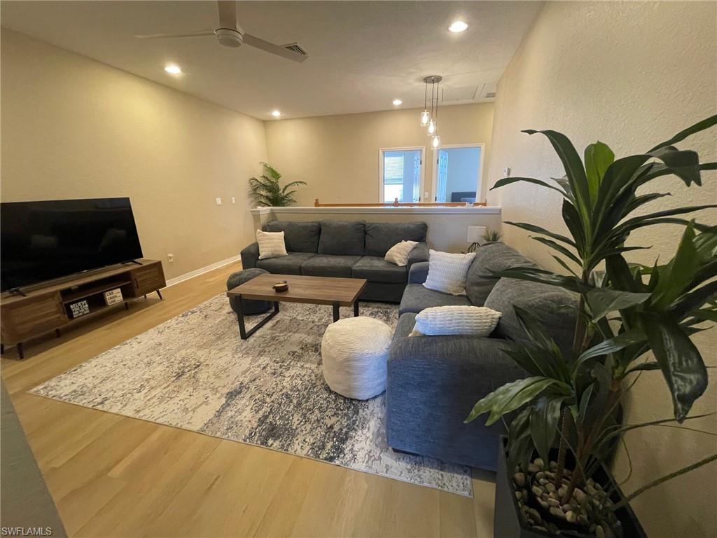 20013 Larino Loop Estero, FL 33928 - Photo 14 of 35 a living room with furniture and a flat screen tv