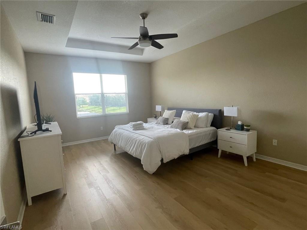 20013 Larino Loop Estero, FL 33928 - Photo 17 of 35 a bedroom with a bed and a flat screen tv