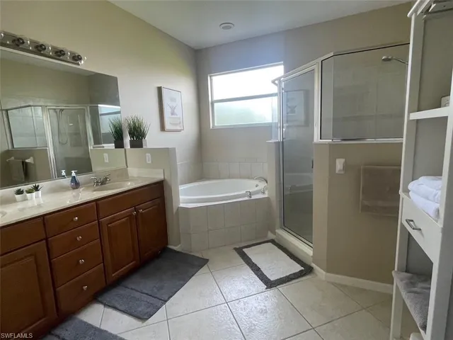 a bathroom with a double vanity sink mirror and toilet