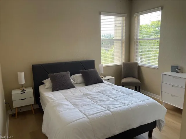 a bedroom with a bed a table and a window