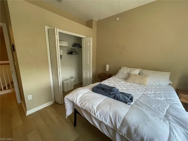 a bedroom with a bed and a mirror