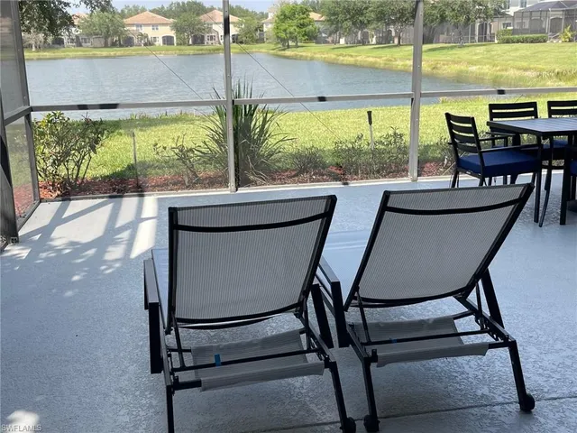 a view of a outdoor kitchen with a table and chairs in the patio