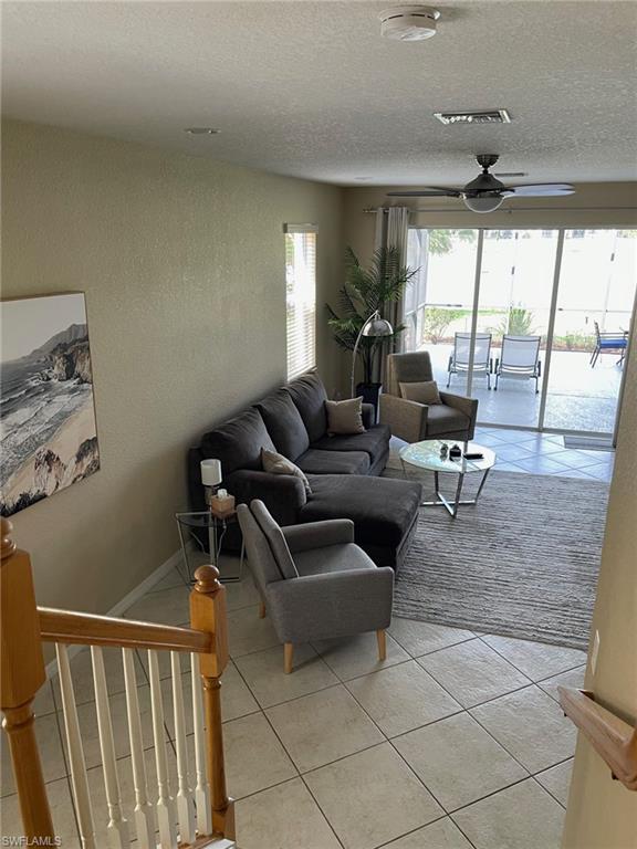 20013 Larino Loop Estero, FL 33928 - Photo 6 of 35 a living room with furniture and a floor to ceiling window