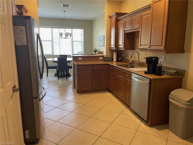 a kitchen with a sink window and cabinets