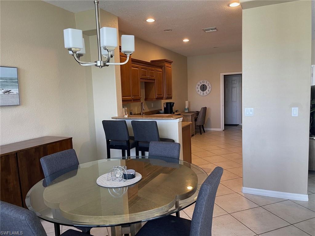 20013 Larino Loop Estero, FL 33928 - Photo 9 of 35 a view of a dining room with furniture