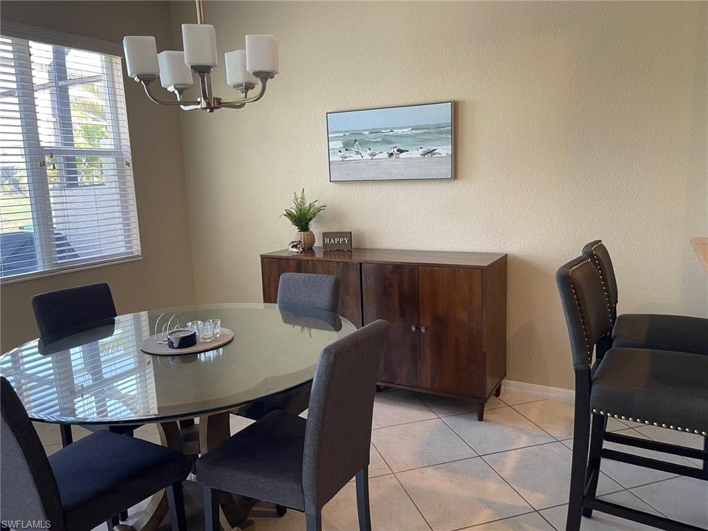 20013 Larino Loop Estero, FL 33928 - Photo 10 of 35 a view of a dining room with furniture and window