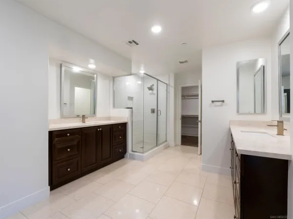 a spacious bathroom with a double vanity sink shower and a mirror