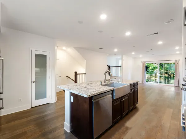 a kitchen with granite countertop a sink and a stove top oven