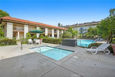 a view of a house with backyard sitting area and garden