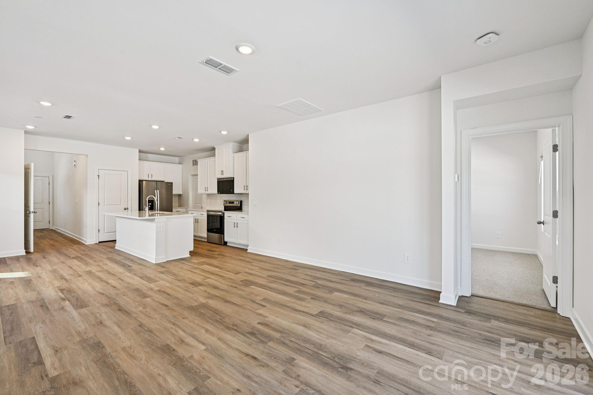 1281 30th St Lane Northeast Conover, NC 28613 - Photo 4 of 37 a view of a kitchen with kitchen island wooden floor and center island