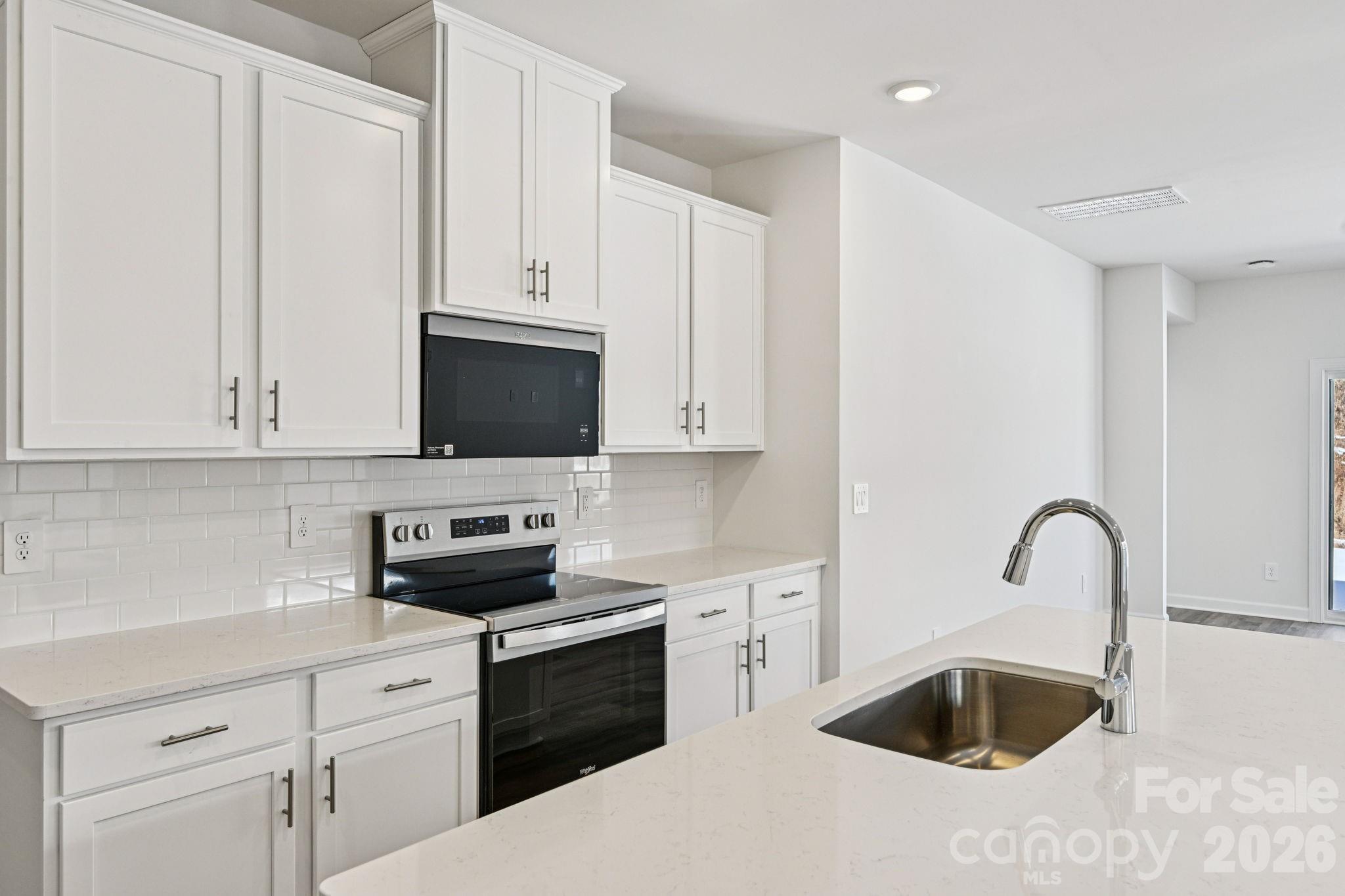 1281 30th St Lane Northeast Conover, NC 28613 - Photo 10 of 37 a kitchen with stainless steel appliances granite countertop a sink a stove and a refrigerator
