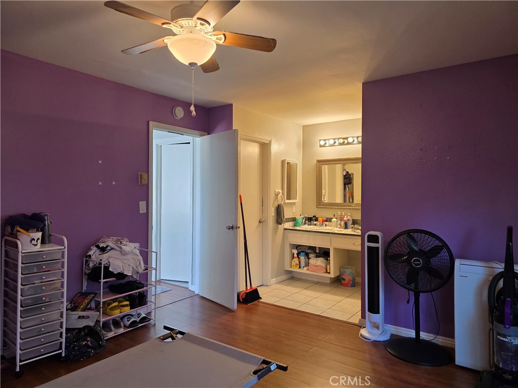 11219 Hood Way Stanton, CA 90680 - Photo 11 of 21 a bed room with a bed and a chandelier