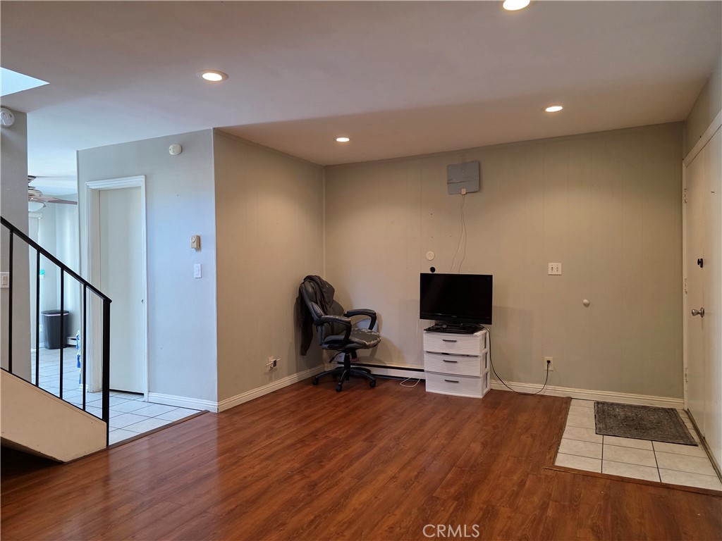 11219 Hood Way Stanton, CA 90680 - Photo 3 of 21 a view of room with wooden floor and a flat screen tv