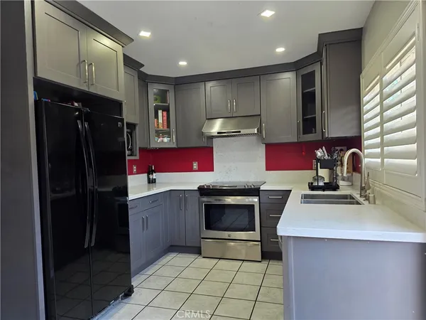 a kitchen with a sink stove and refrigerator