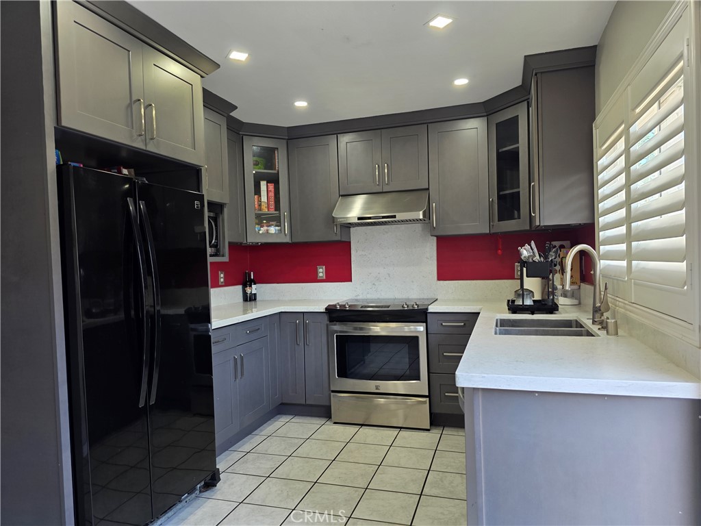 11219 Hood Way Stanton, CA 90680 - Photo 5 of 21 a kitchen with a sink stove and refrigerator