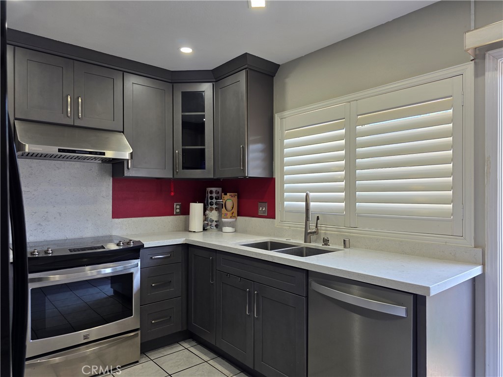 11219 Hood Way Stanton, CA 90680 - Photo 7 of 21 a kitchen with stainless steel appliances granite countertop a sink stove and cabinets