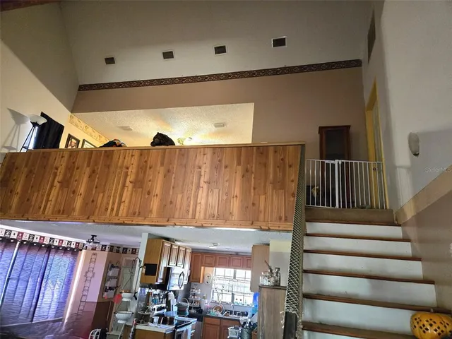 a bathroom with a sink a toilet a window and shower