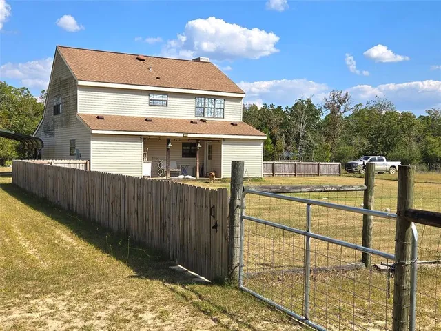 a view of outdoor space with swimming pool and trees in the background