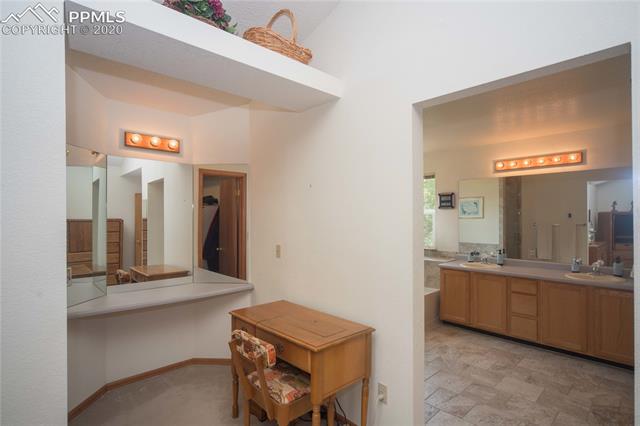 6695 Turkey Tracks Road Colorado Springs, CO 80922 - Photo 15 of 34 Sitting area and adjoining bath in master bedroom