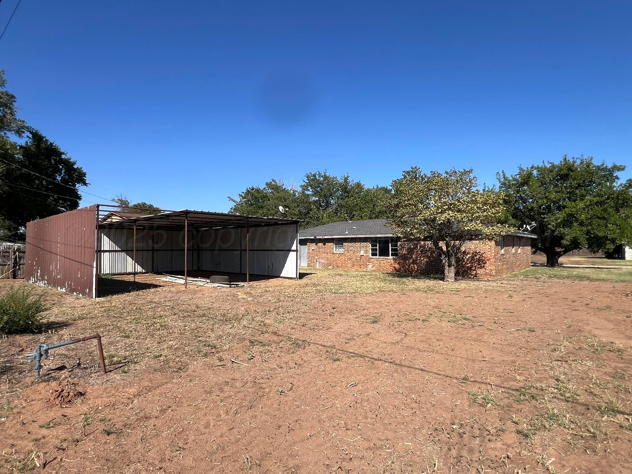 2005 North 20th Street Memphis, TX 79245 - Photo 17 of 19 a pathway of a house with a yard