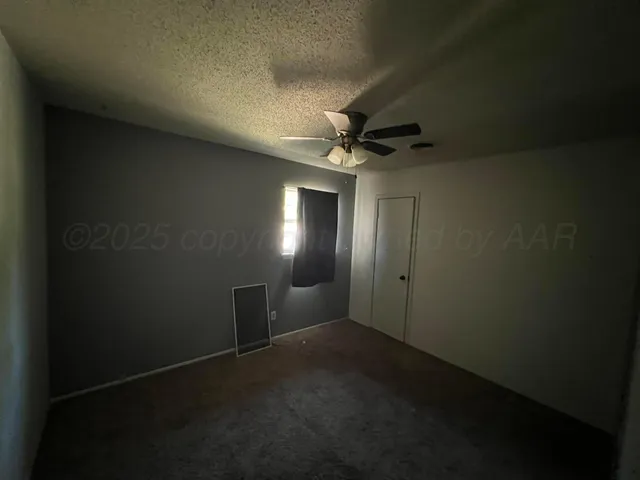 a view of a livingroom and a chandelier fan