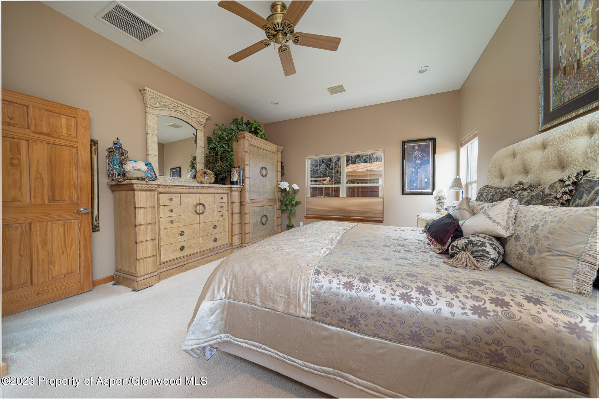 a bedroom with a large bed and dresser