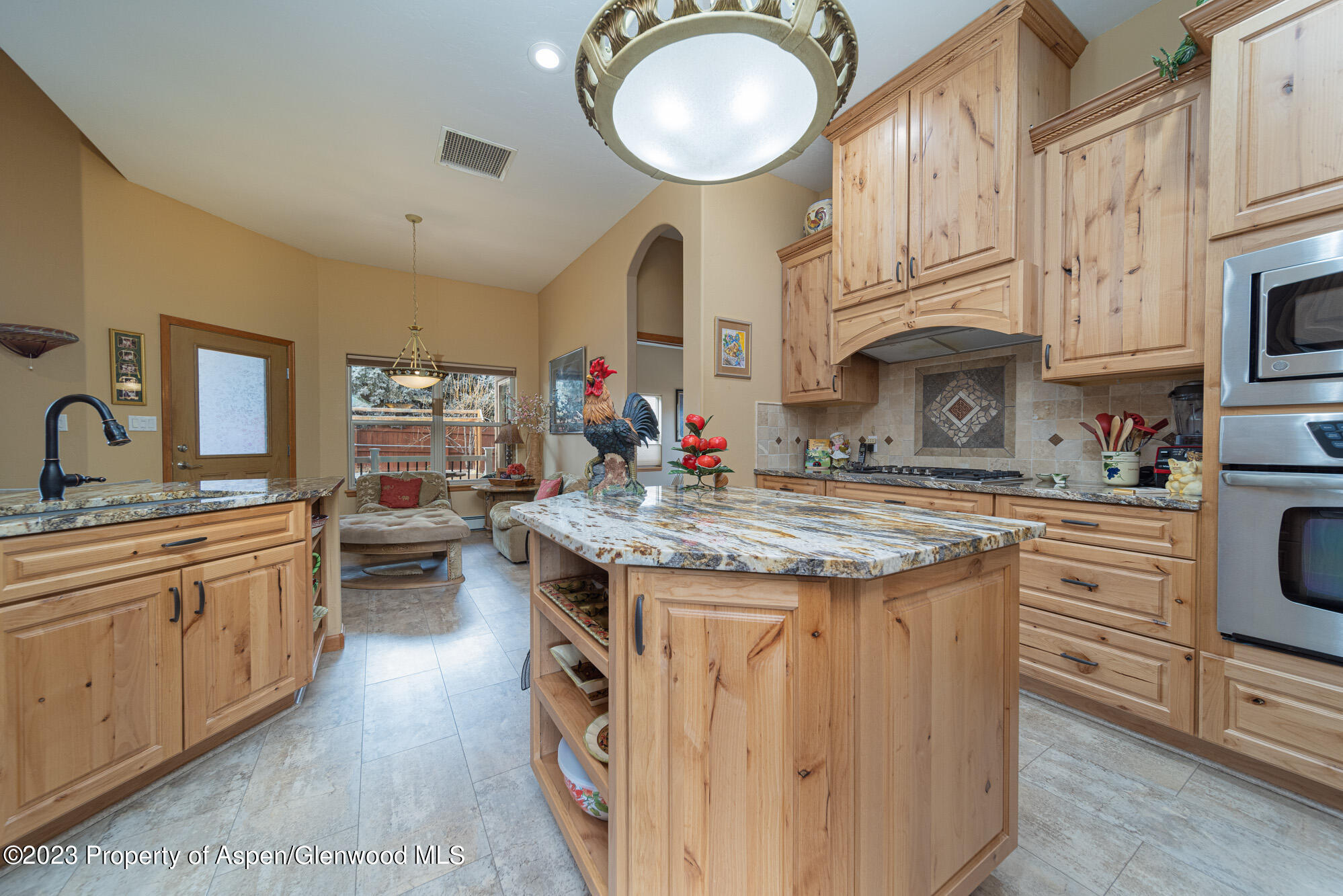 685 Roundup Drive Grand Junction, CO 81507 - Photo 11 of 39 a kitchen with stainless steel appliances granite countertop a stove a sink and a refrigerator